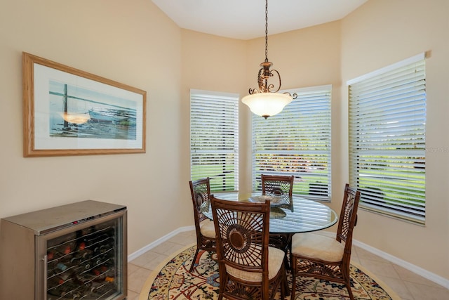 dining space with tile floors and beverage cooler