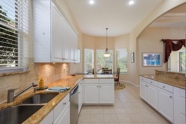 kitchen with plenty of natural light, white cabinetry, and light tile floors