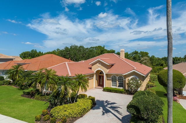 mediterranean / spanish-style house with a front lawn