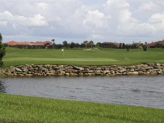 view of nearby features with a water view and a lawn