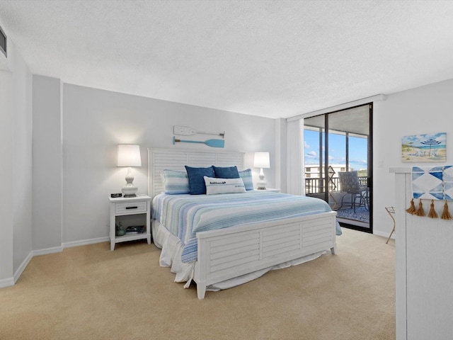 bedroom featuring a textured ceiling, access to exterior, and light colored carpet