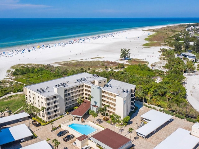 birds eye view of property with a water view and a view of the beach