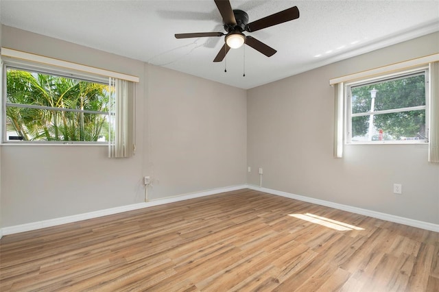 unfurnished room with ceiling fan and light hardwood / wood-style flooring