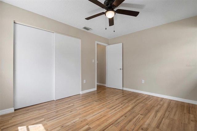 unfurnished bedroom with a closet, ceiling fan, and light hardwood / wood-style flooring