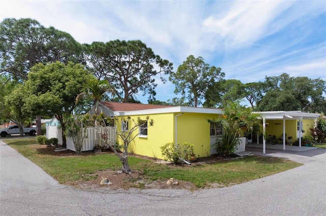 view of front of property featuring a carport