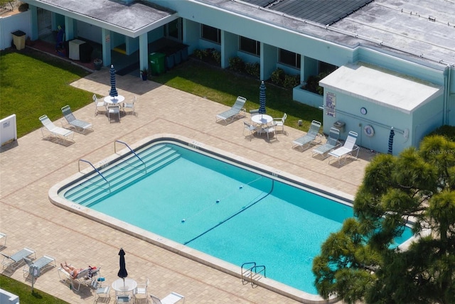 view of swimming pool with a lawn and a patio