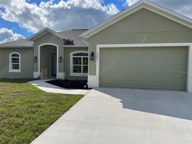 single story home featuring a front yard and a garage