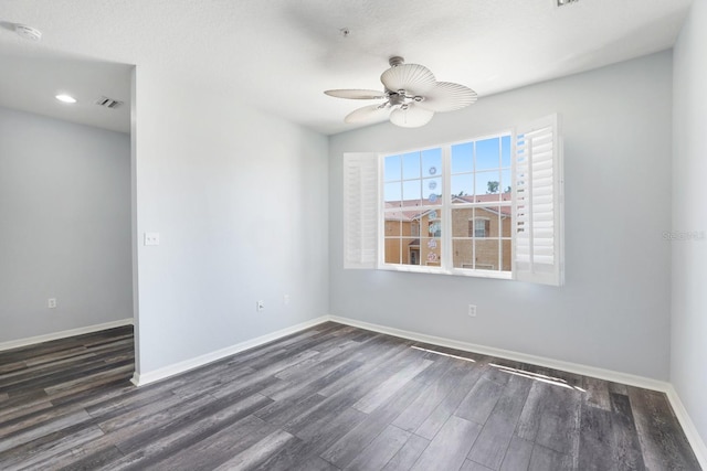 spare room with ceiling fan, dark wood-type flooring, and a textured ceiling