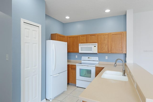 kitchen with light tile patterned floors, kitchen peninsula, white appliances, a textured ceiling, and sink