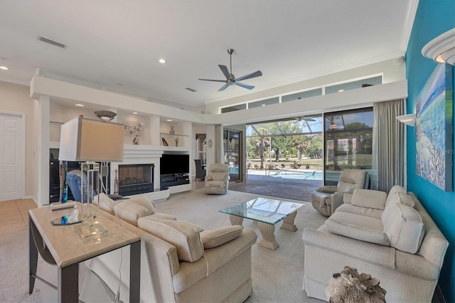 carpeted living room featuring ceiling fan, crown molding, and a towering ceiling