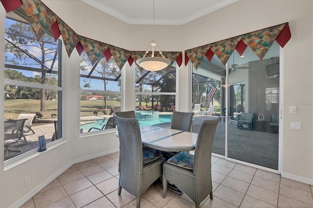 tiled dining area featuring ceiling fan and crown molding