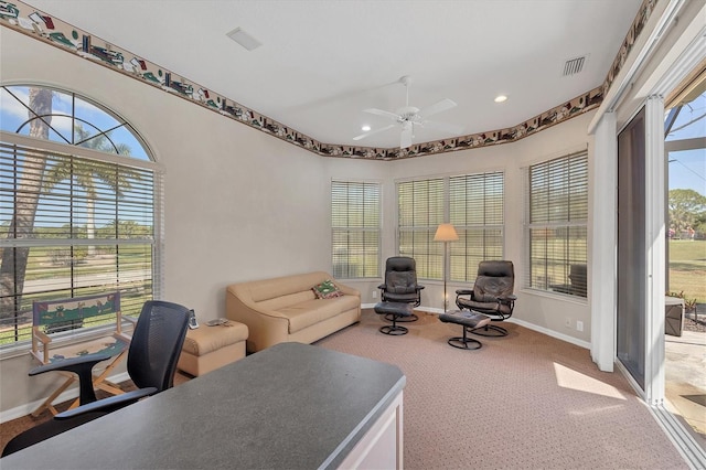 office featuring a wealth of natural light, ceiling fan, and carpet floors