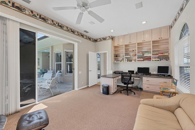 office featuring light carpet and ceiling fan