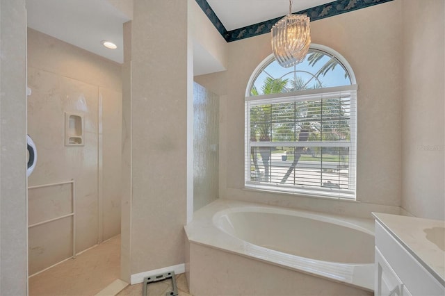 bathroom with tile patterned floors, independent shower and bath, vanity, and a chandelier