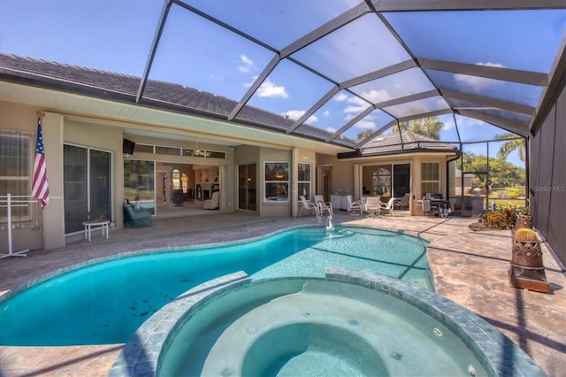 view of swimming pool featuring glass enclosure, ceiling fan, a patio area, and an in ground hot tub