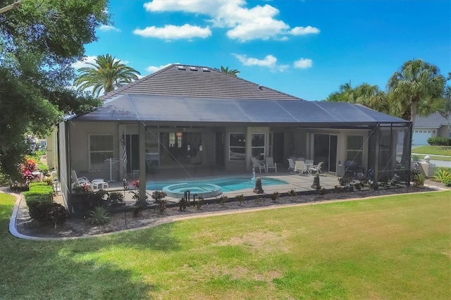 back of property with glass enclosure, a patio area, and a yard