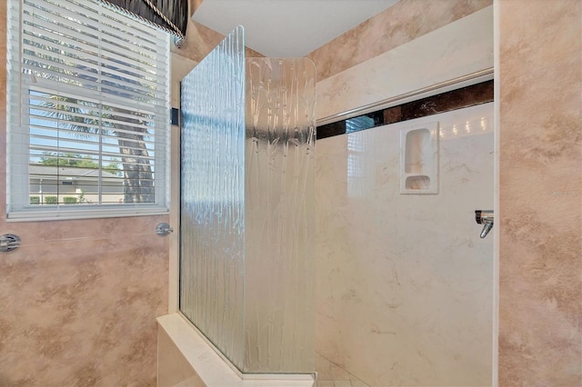 bathroom with a shower and a healthy amount of sunlight