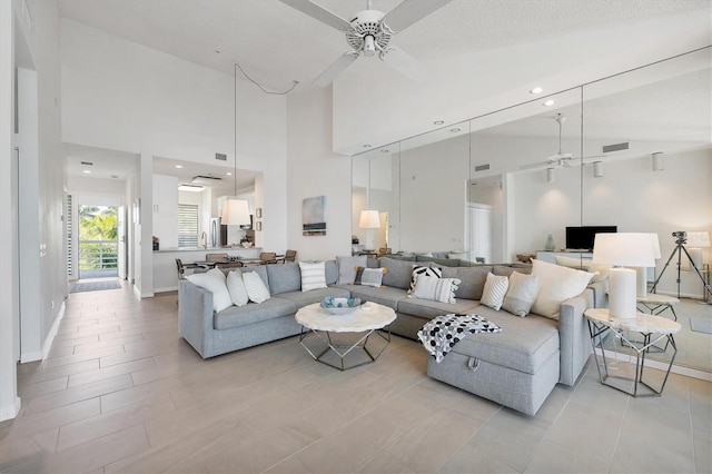 living room with high vaulted ceiling and ceiling fan