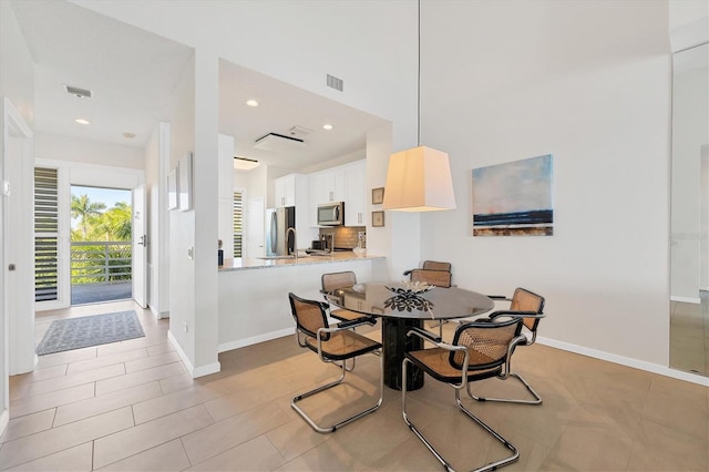 dining space with sink and light tile patterned floors