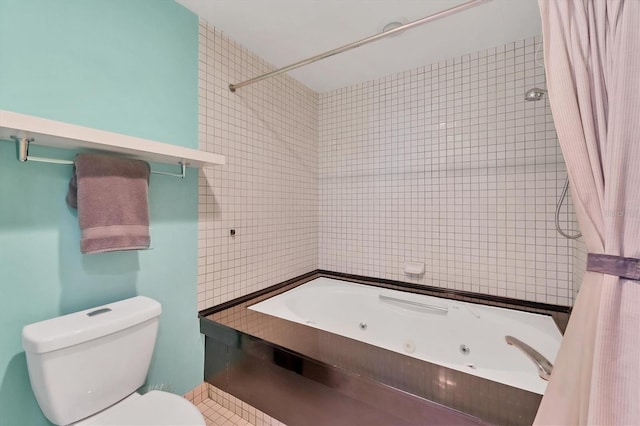 bathroom with tile walls, toilet, and shower / bath combo