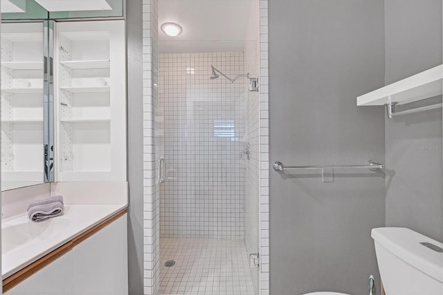 bathroom with vanity, an enclosed shower, and toilet