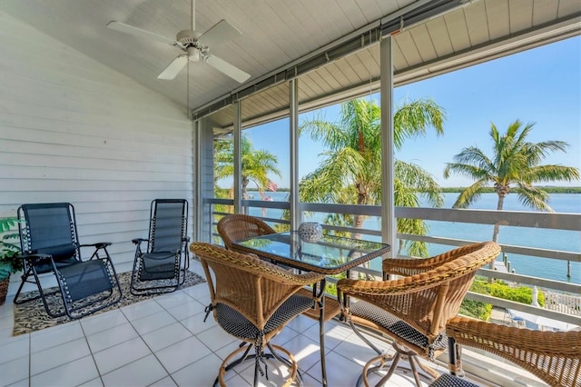 sunroom / solarium featuring vaulted ceiling, a water view, a wealth of natural light, and ceiling fan