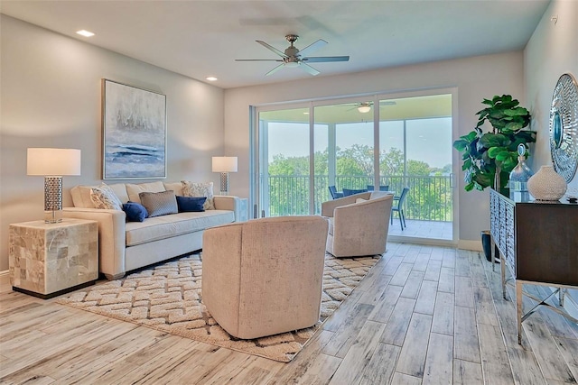 living room featuring ceiling fan and light hardwood / wood-style floors