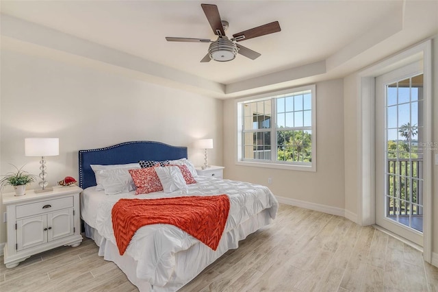 bedroom with multiple windows, light hardwood / wood-style floors, and ceiling fan