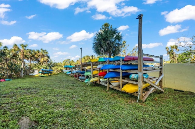 view of dock featuring a lawn