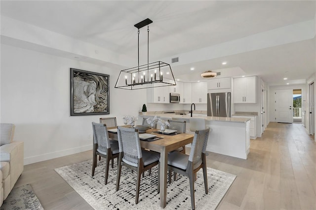 dining area featuring recessed lighting, light wood-type flooring, visible vents, and baseboards