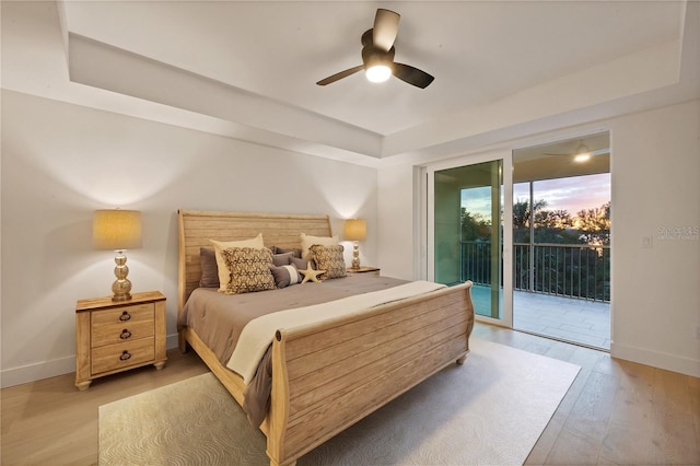 bedroom with a ceiling fan, access to outside, light wood-style flooring, and baseboards