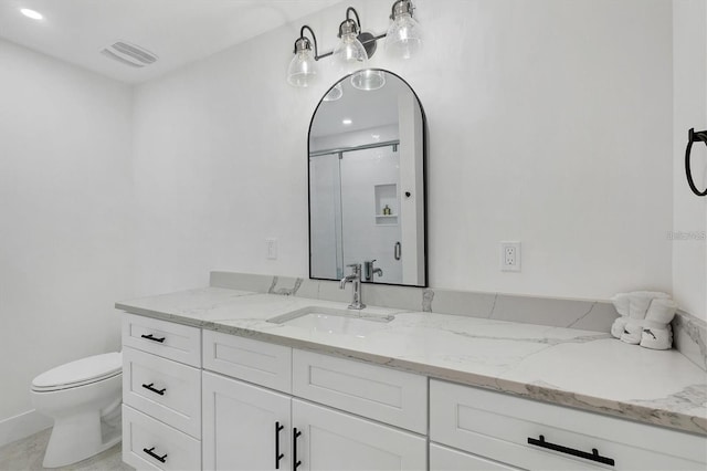 full bath with a stall shower, visible vents, vanity, and toilet