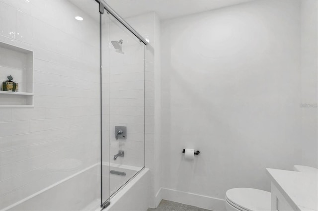 full bathroom featuring toilet, shower / bath combination with glass door, baseboards, and vanity