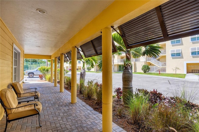 view of patio / terrace featuring covered porch and a residential view