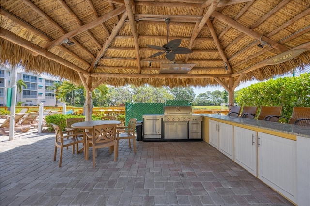 view of patio with a gazebo, outdoor dining area, and area for grilling