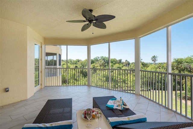 sunroom / solarium featuring a wealth of natural light and ceiling fan