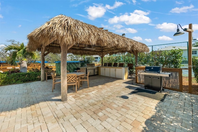 view of patio featuring a gazebo, area for grilling, and an outdoor kitchen