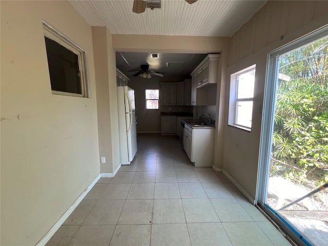 interior space with light tile patterned floors and sink