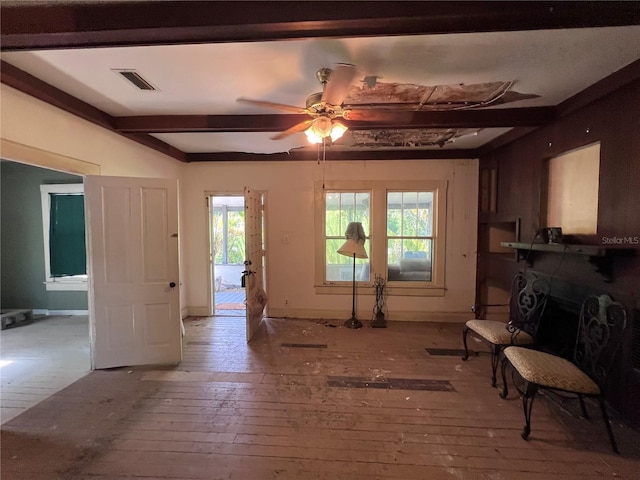 living room with beamed ceiling, ceiling fan, a healthy amount of sunlight, and hardwood / wood-style flooring