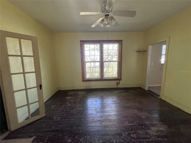 unfurnished room with ceiling fan and dark hardwood / wood-style flooring