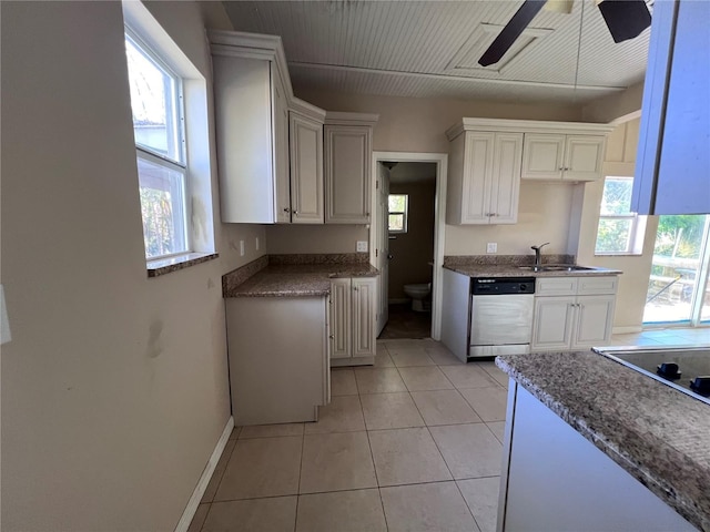 kitchen with stainless steel dishwasher, ceiling fan, sink, light tile patterned floors, and white cabinetry