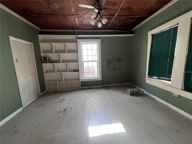 unfurnished room featuring ceiling fan, hardwood / wood-style floors, and crown molding