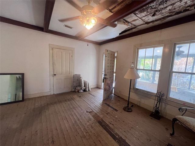 interior space featuring beamed ceiling, ceiling fan, and wood-type flooring