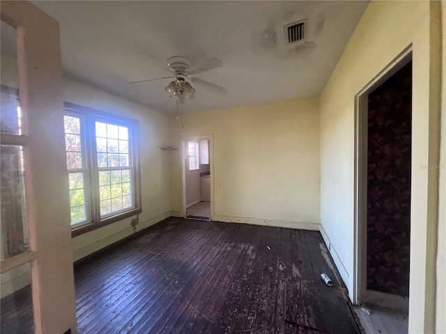 unfurnished room with ceiling fan and dark hardwood / wood-style flooring