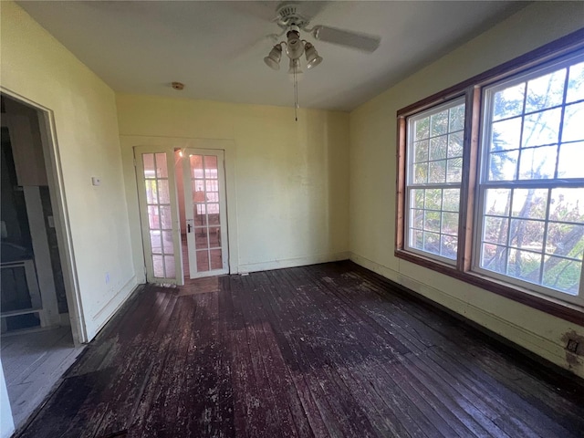 unfurnished room with ceiling fan, french doors, and dark wood-type flooring