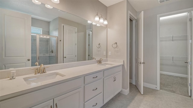 bathroom featuring vanity and an enclosed shower