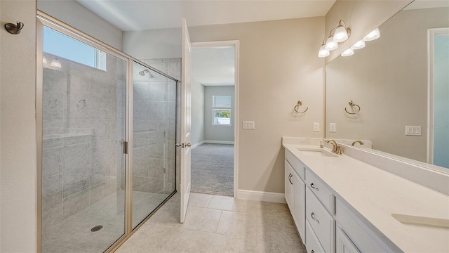 bathroom with a shower with shower door, tile patterned floors, and vanity