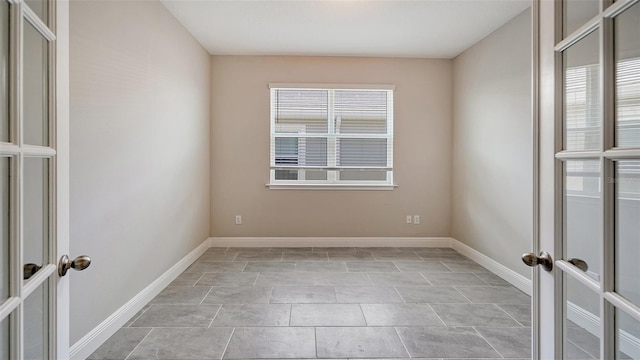 spare room featuring french doors