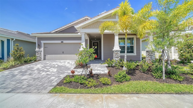 craftsman house featuring a garage and decorative driveway