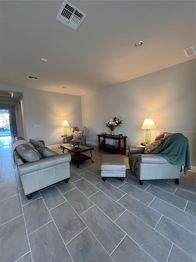 living area with visible vents and baseboards